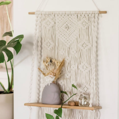 centered shot of the while wall with a Macrame shelf Sage and Twine Co.