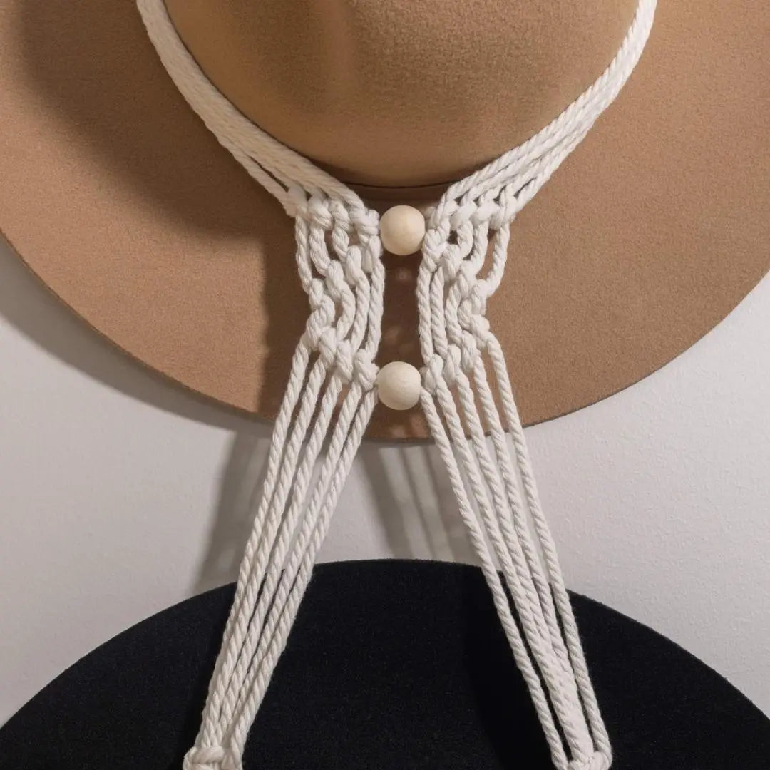 Close up showing the intricate macrame hat hanger cotton threads and woven mid section of a sage and twine macrame hat hanger.